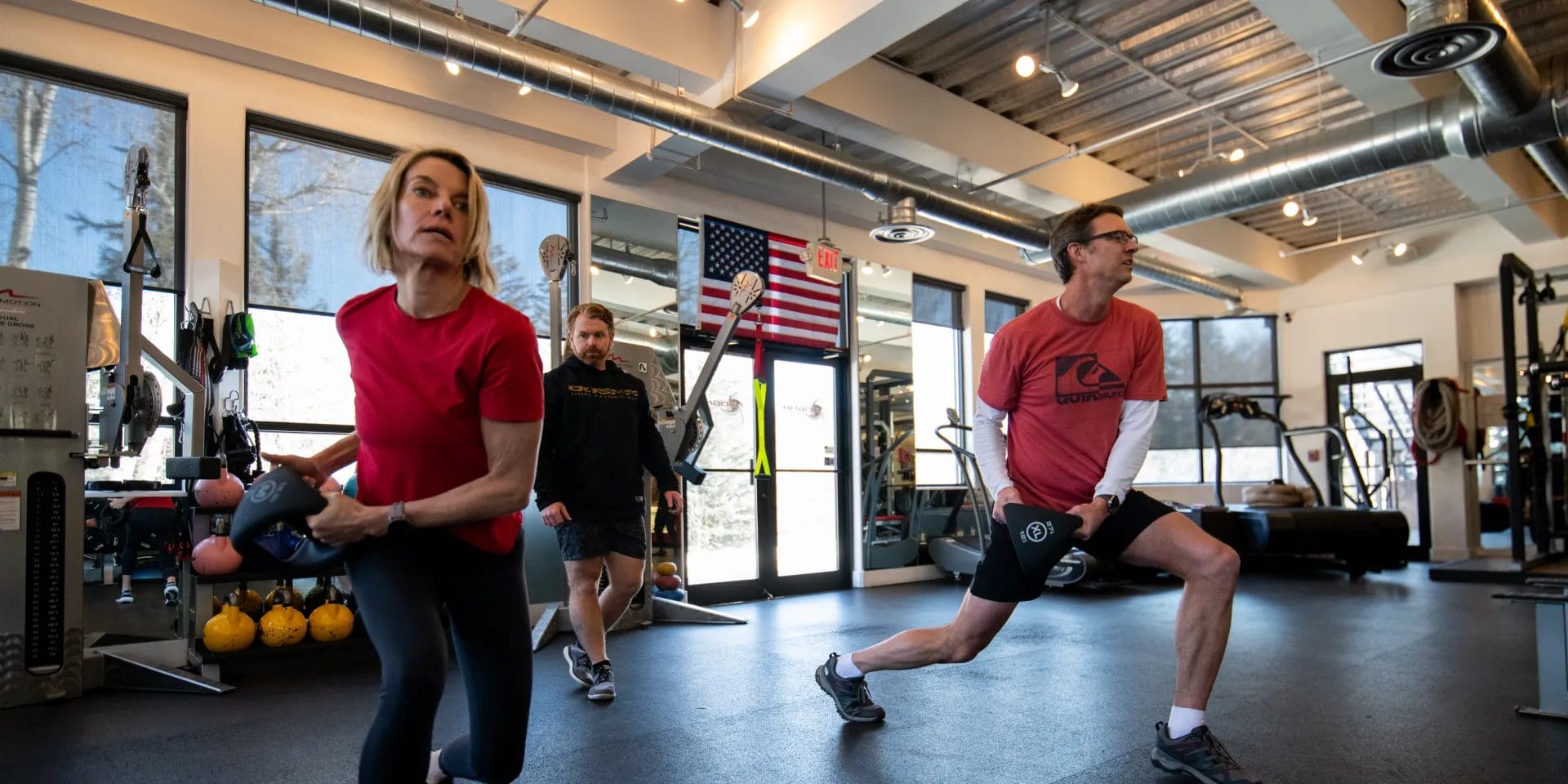 Woman and man working out with YBell